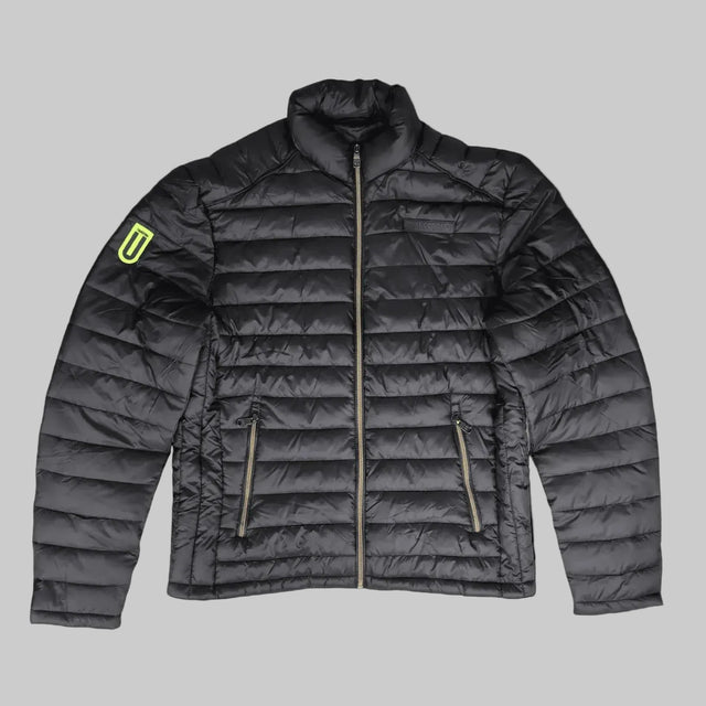 A dark gray quilted puffer jacket with a high collar, front zipper, and two zippered hand pockets. A bright neon yellow-green shield logo is visible on the left sleeve.