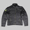 A dark gray quilted puffer jacket with a high collar, front zipper, and two zippered hand pockets. A bright neon yellow-green shield logo is visible on the left sleeve.