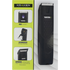 Black body grooming tool next to its packaging on a gray surface