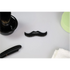 Black moustache comb with 'TRANSFORM U' branding on a white surface with grooming items.