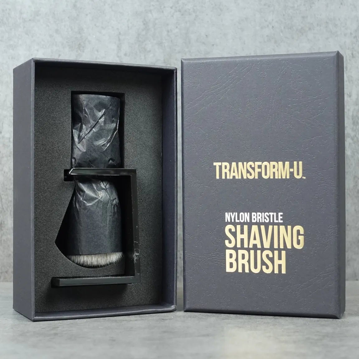 Transform-U shaving brush in packaging on a gray background