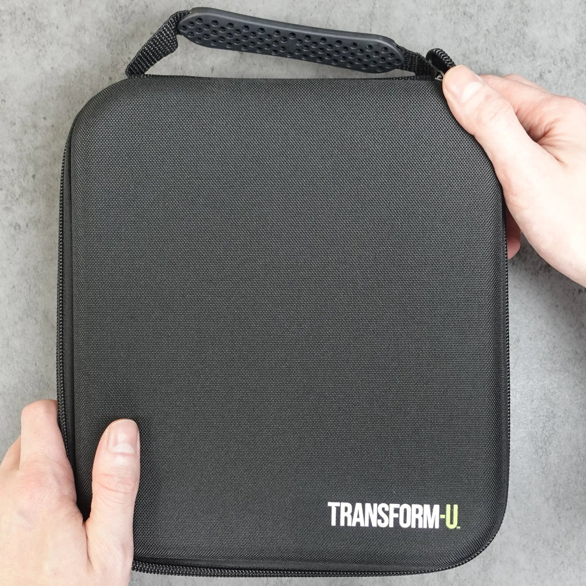 a black travel case for a hair clipper on dark background