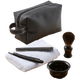 Set of grooming tools including a black leather pouch, comb, brush, towel, and bowl on a transparent background.