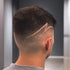 Man with a stylish haircut featuring a line design on the back of his head.
