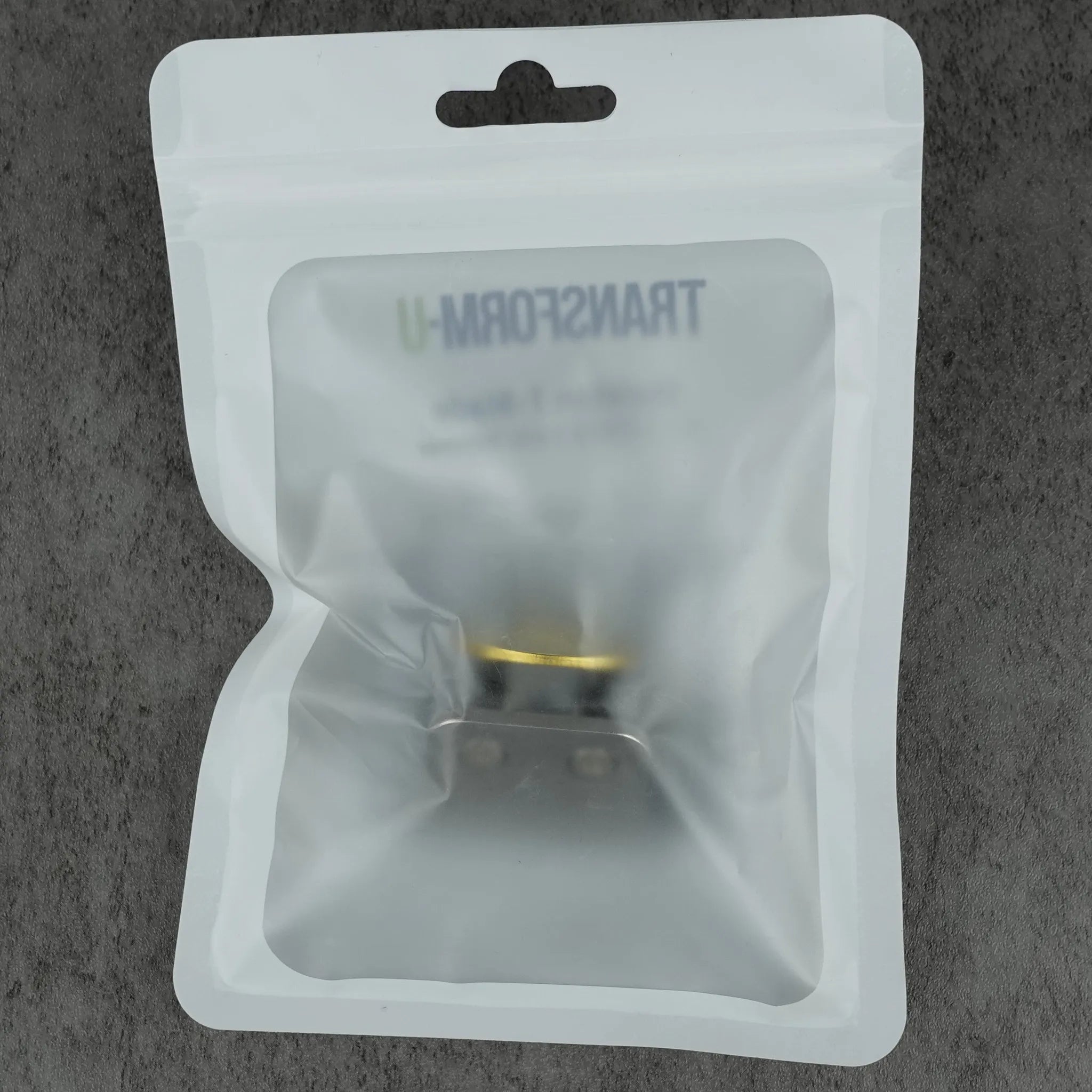 Clear plastic packaging with a visible brand name on a gray background